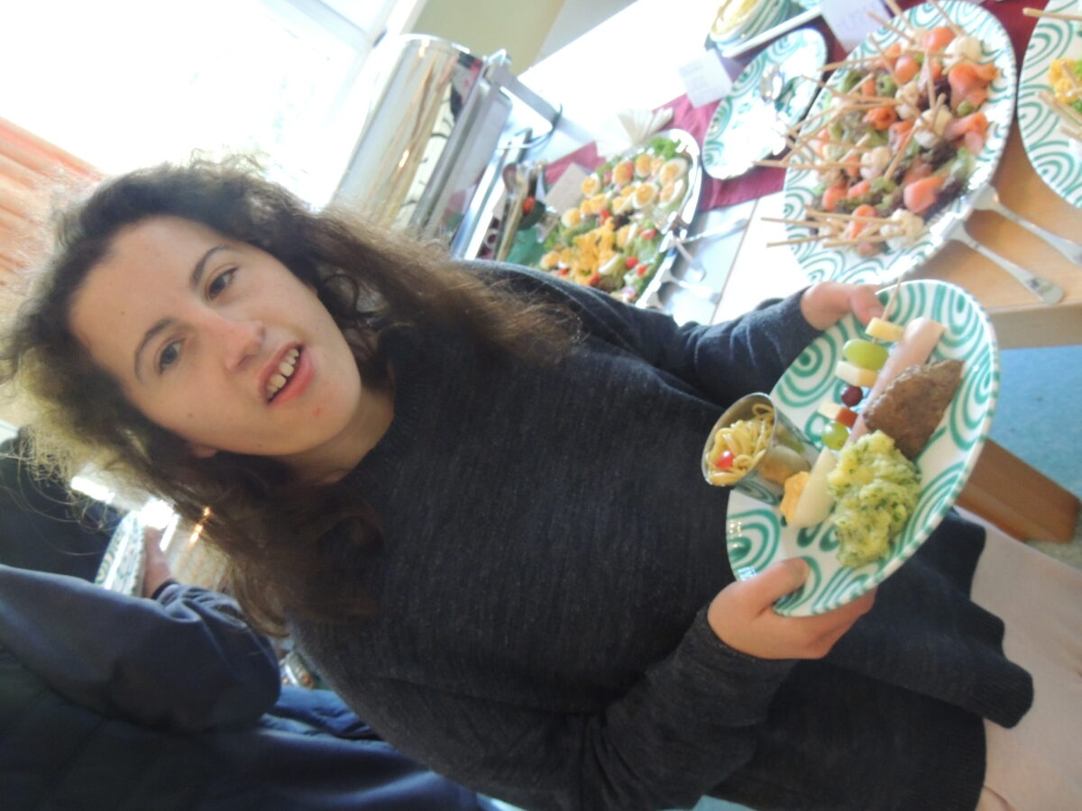 Frau mit Teller auf dem Essen vom Buffett liegt
