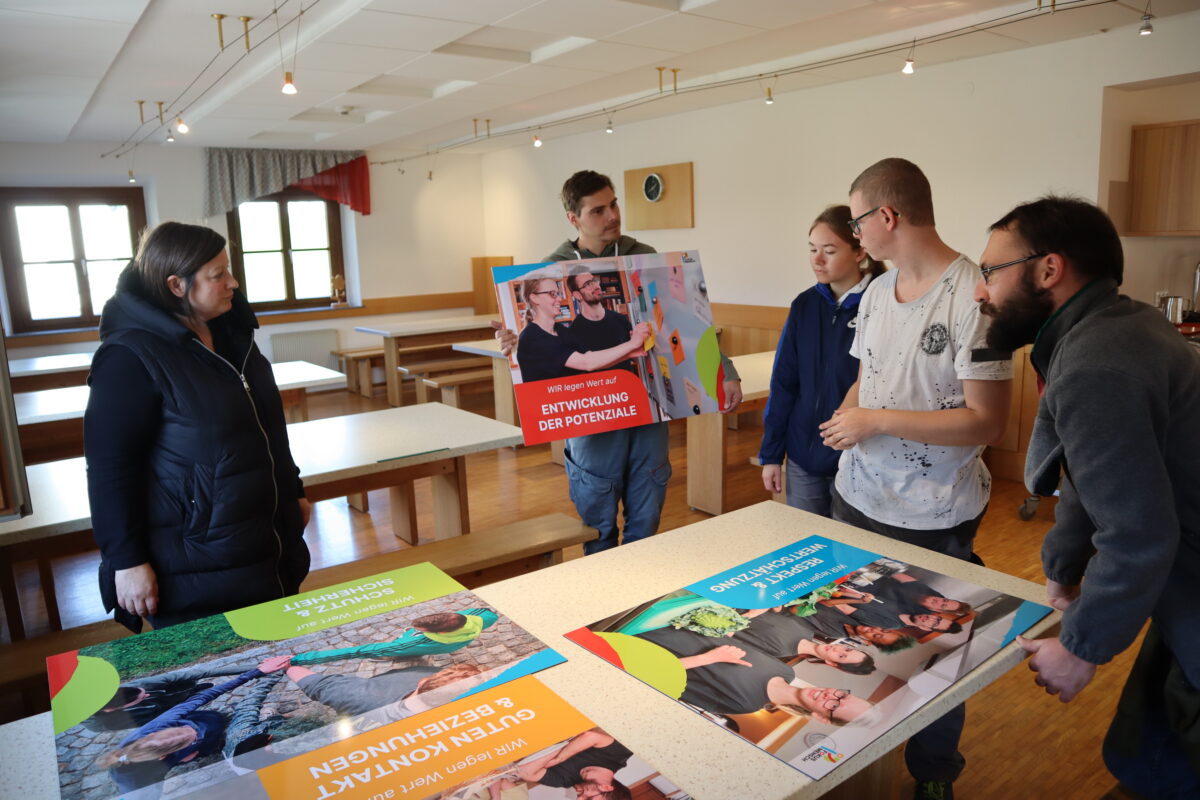 Gruppe junger Menschen mit Schautafeln